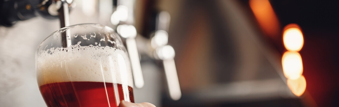 Bartender pouring a draught beer.