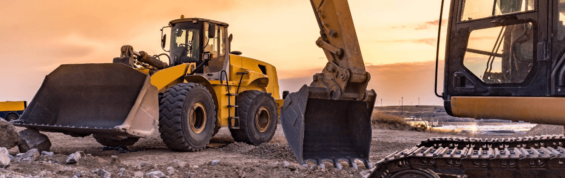 Two yellow construction vehicles  