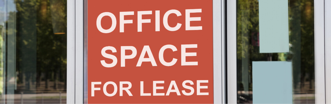“For lease” sign on the door of a commercial building.