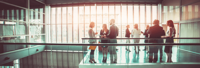 corporate colleagues standing in corridor and talking