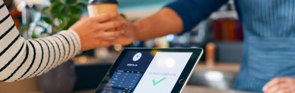 Man buying coffee at after completing the payment