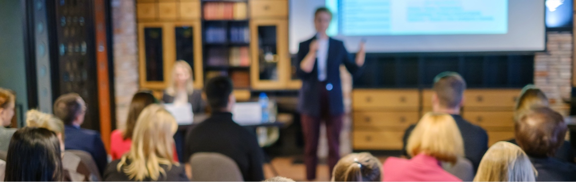 Businessperson presenting in person in front of an audience Businessperson presenting in person in front of an audience.