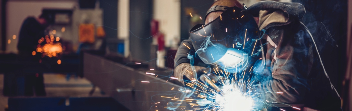 Industrial welder in a manufacturing plant.